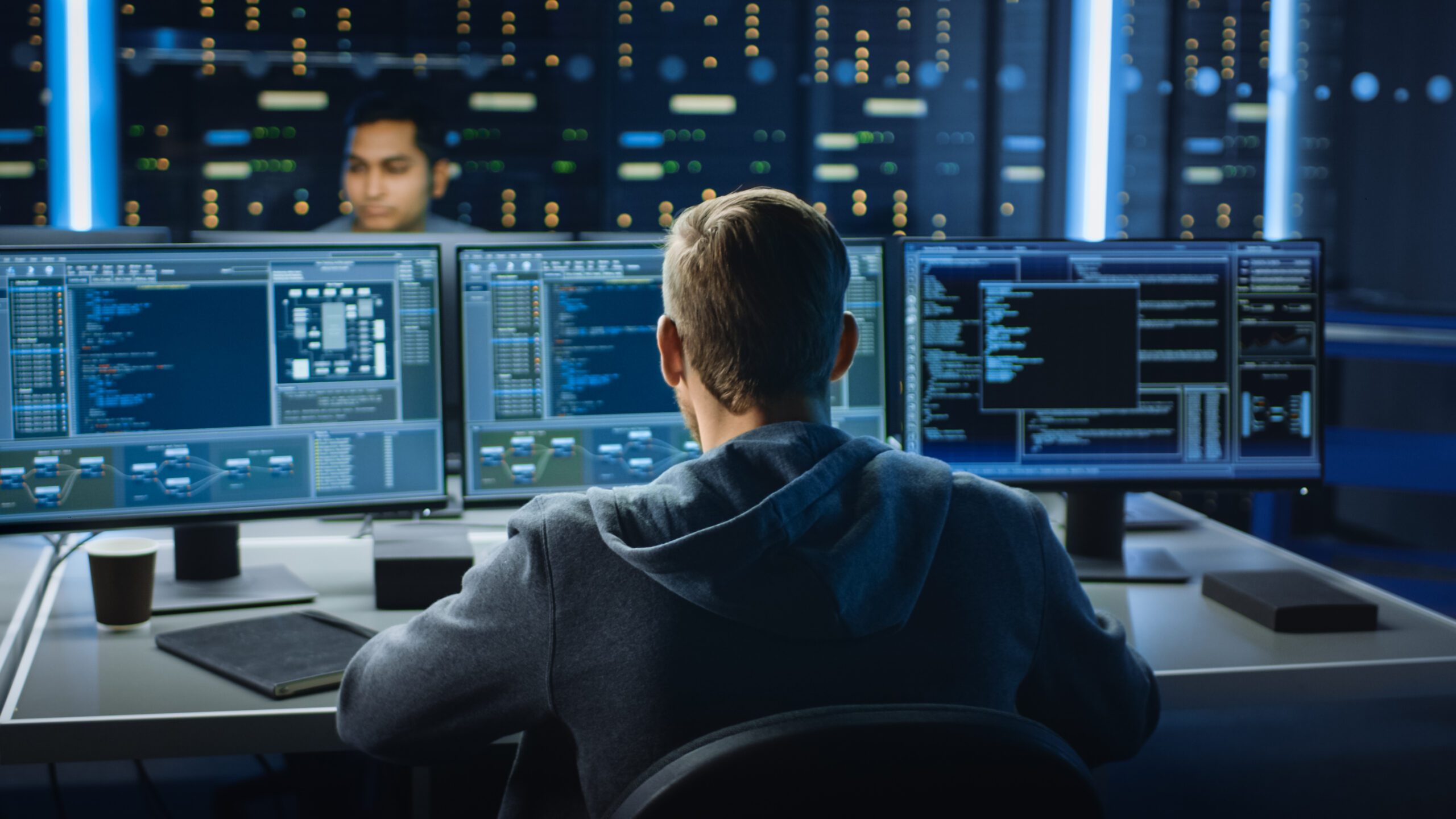 Tech support team in front of computer screens