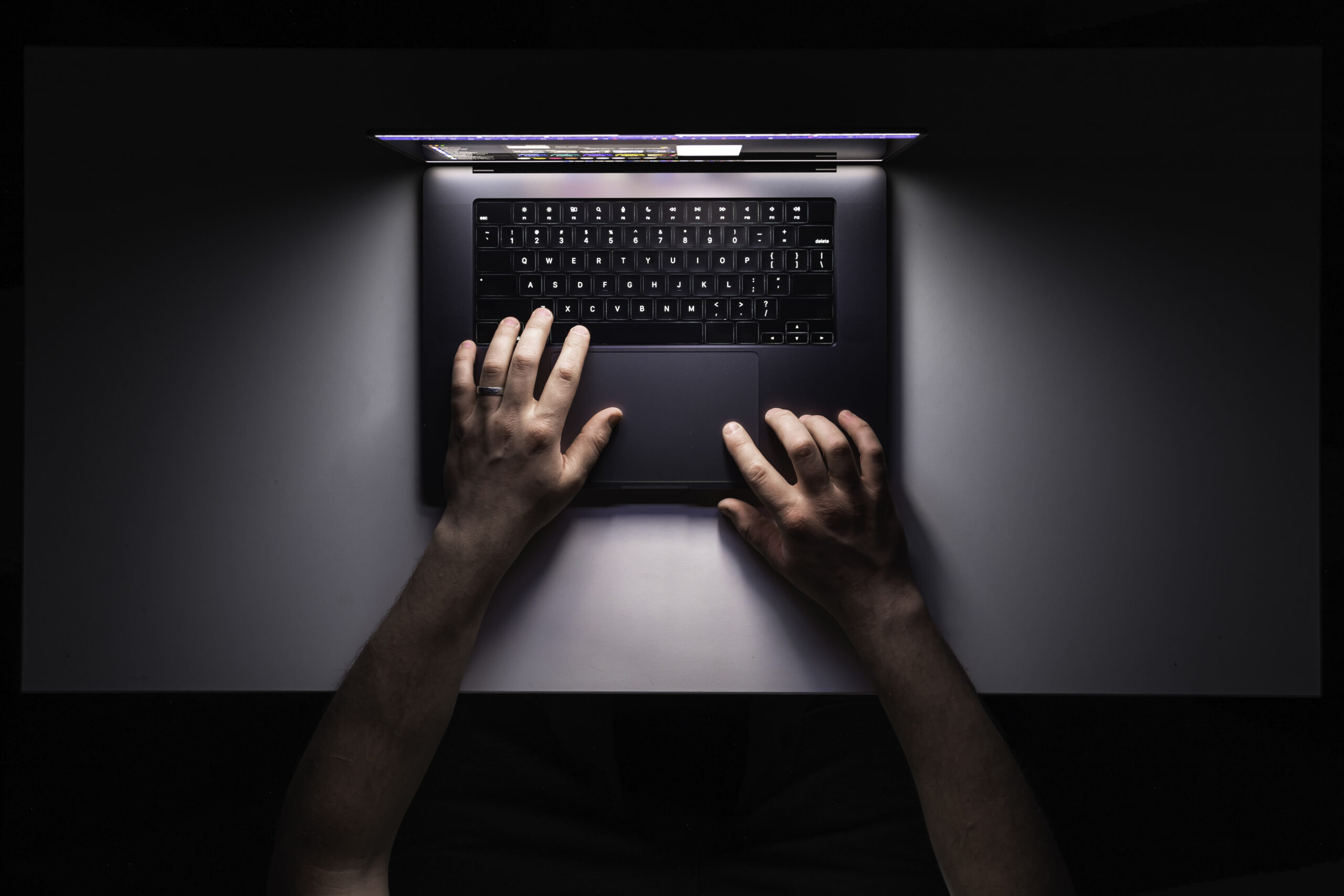 man-using-laptop-night-workplace-top-view